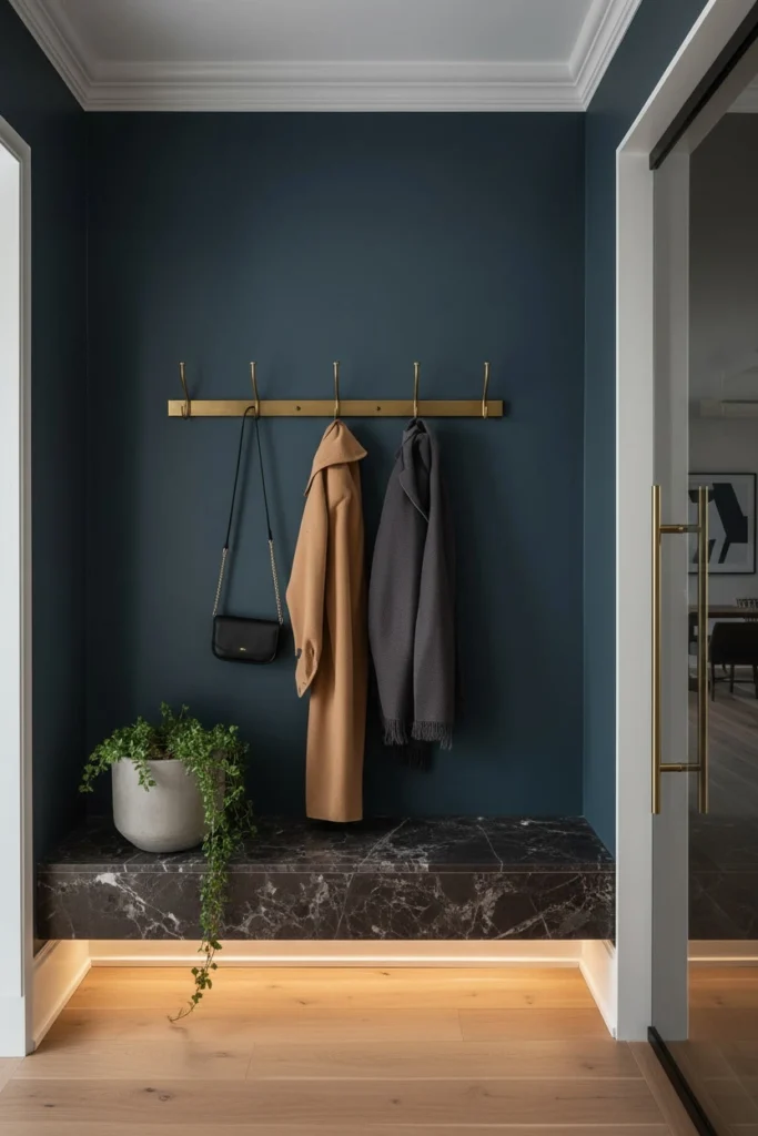 Wooden coat and hook rail mounted on hallway wall.