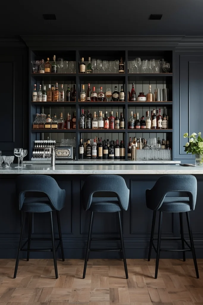 Dark navy wall creating dramatic home bar backdrop.