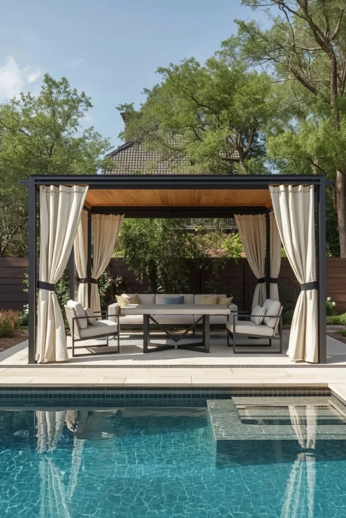 Small open-sided pavilion with curtains beside pool